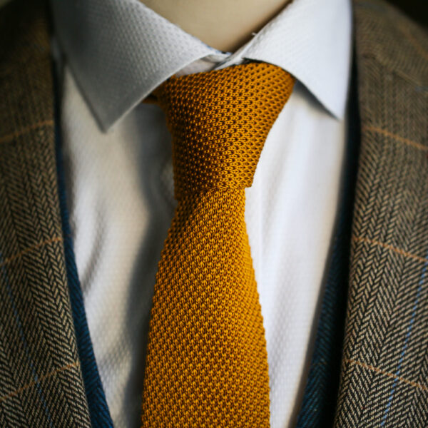 Gold knitted tie from Marc Darcy
